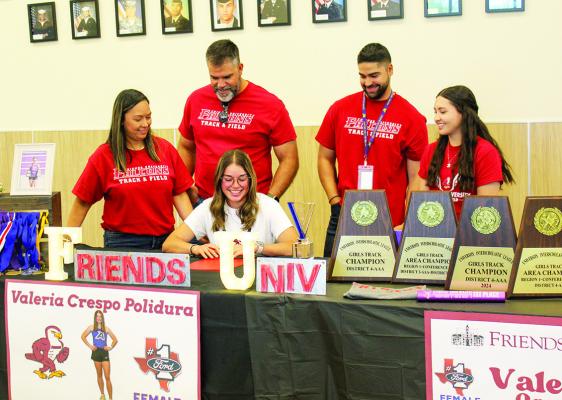 Alpine Lady Buck track and field champion Valeria Crespo Polidura signed with Friends University in Wichita, Kansas on Tuesday afternoon along with receiving the award for the February Ford Female Athlete of the Month. Crespo Polidura is pictured here with her family in the Alpine High School cafeteria. Photo by Joh Covington