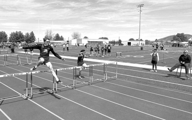 Martin Sablatura clears a hurdle in this past Saturday’s Fightin’ Buck Relays at Buck Stadium. Sablatura placed second in the 110M hurdles and first in the 300M hurdles. Photo by J.T. Maroney