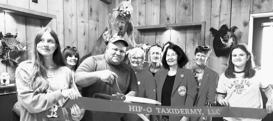A ribbon cutting ceremony was held last Friday evening for the new owners of Hip-O Taxidermy. Pictured are Sage Parsons, Dona Ward, owner Howard Parsons, Geri Davis, Rhonda Cole, Sarah Bow-Gluck, Judy Stokes, and Cadence Parsons. Photo by Kara Gerbert