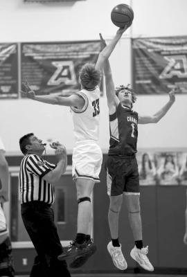 Alpine Fightin’ Buck Zane Wash reaches for the ball during the tip-off at the Buck’s last game against Crane. Photo by Annika Canaba