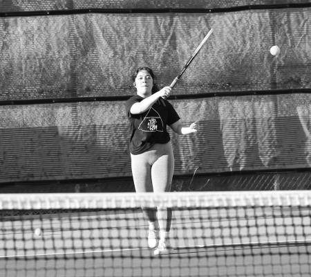 Vianney Santos perfects her swing during practice early in the season. Photo by Joh Covington.