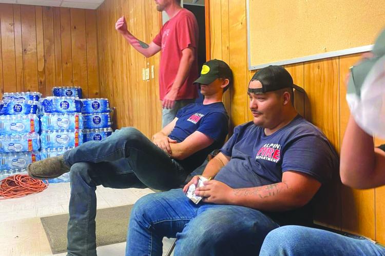 This past Sunday, June 2, the Alpine Volunteer Fire Department responded to the tornado that descended upon the town of Sanderson. AVFD sent three members of their team along with one apparatus full of supplies and water and was just one of several area first responders to render aid to the town Sunday night. Pictured are members of the AVFD resting between jobs before they arrived back in Alpine around 2 a.m. Monday morning.