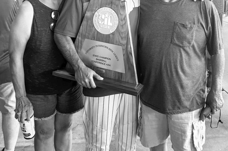Ben Gallego (center) is pictured here with his parents Linda (left) and B.J. (right) showing off the UIL trophy won by the State Champion Franklin Lions.