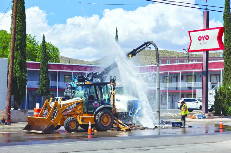 The City of Alpine works on a water leak Monday afternoon in front of the OYO hotel. Workers inside the hole cool off a bit during the repair as water shoots into the air from the waterline on East Holland Avenue. Photo by Kara Gerbert